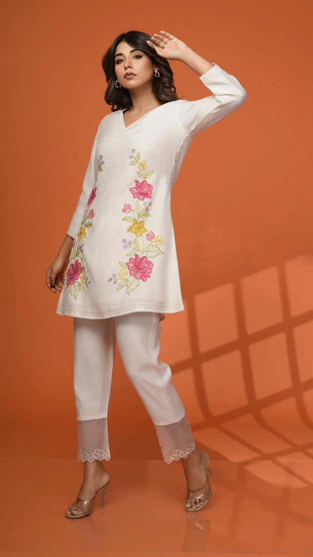 White floral embroidered kurta with matching pants and lace cuffs