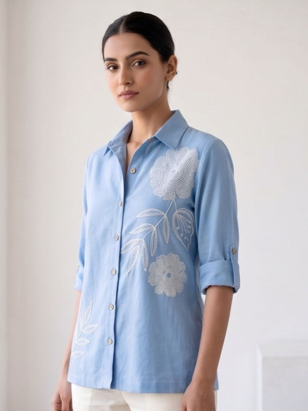 Light blue button-down cotton shirt with collar, 3/4 sleeves, floral embroidery detail at front