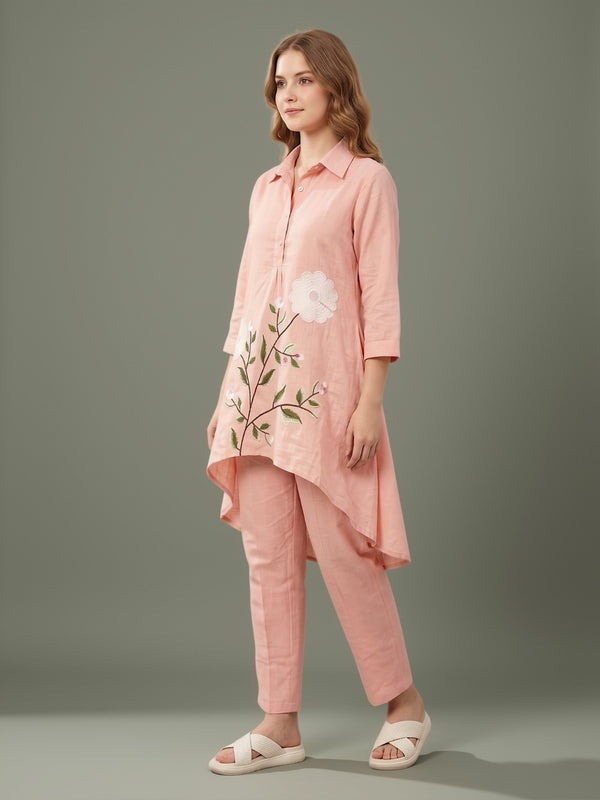 Women’s blush pink asymmetric kurta set with floral applique, paired with straight pants