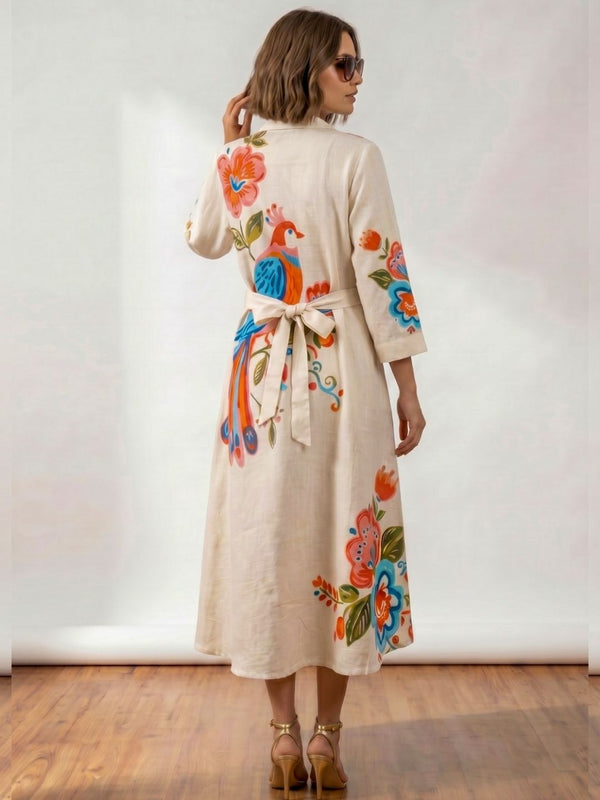 Ivory tunic dress with peacock floral print, collared neckline, and tied waist at back