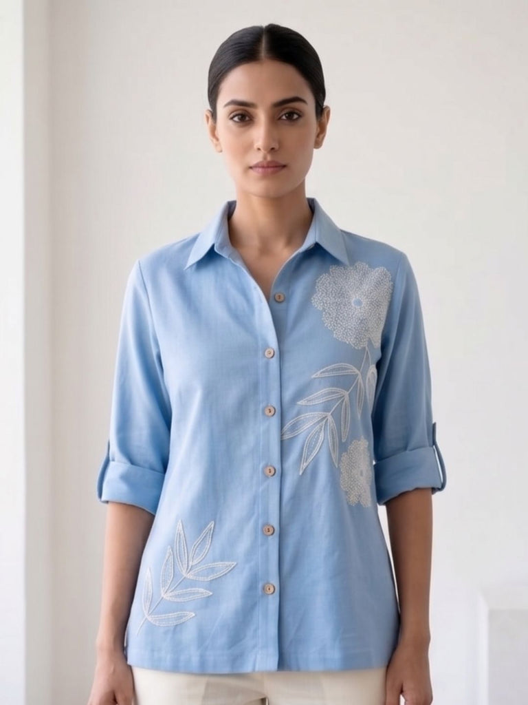 Light blue button-down cotton shirt with collar, 3/4 sleeves, floral embroidery on chest